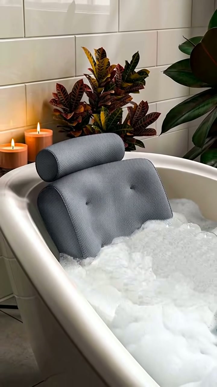 A cushioned bath pillow for neck and shoulder support